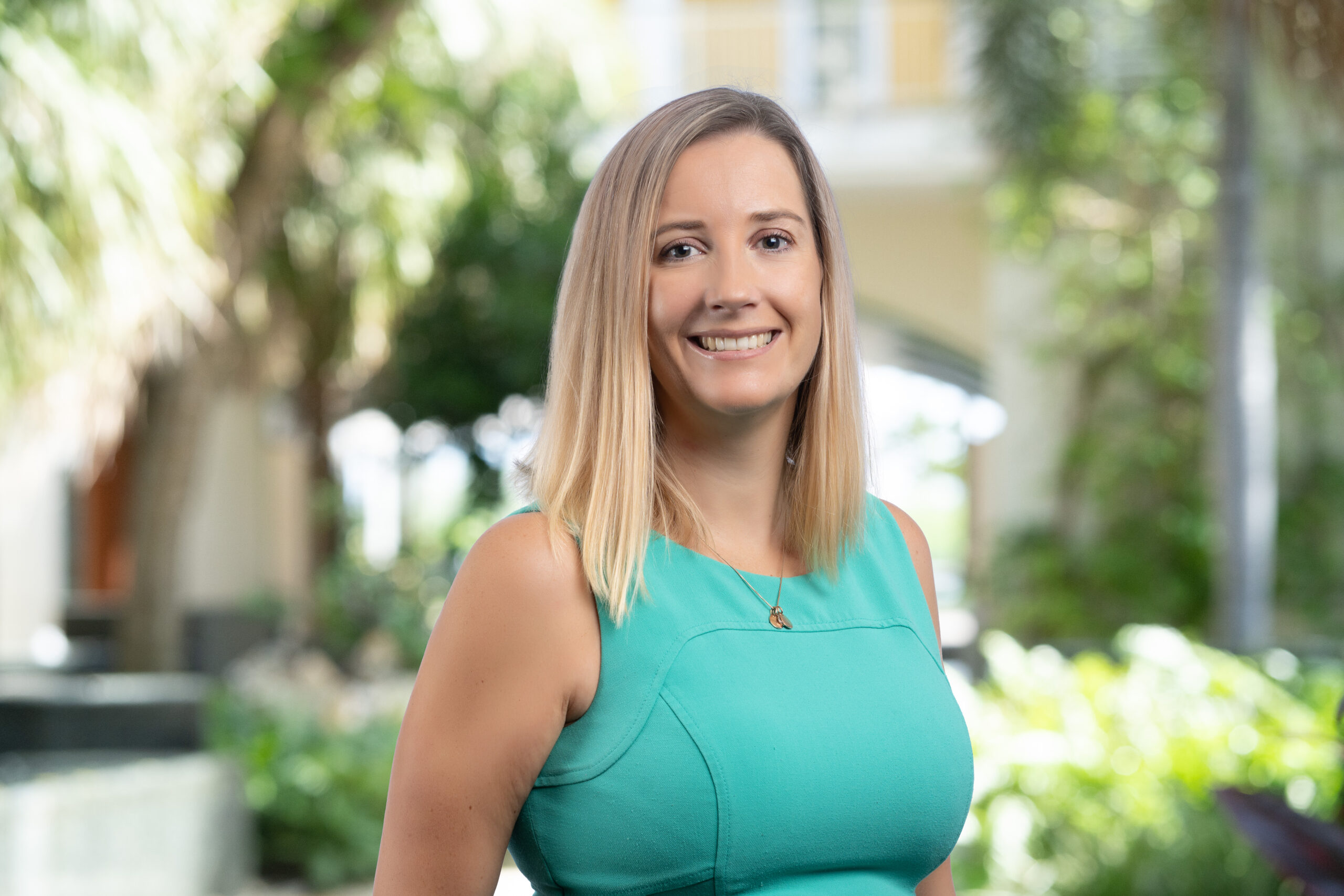 Alanna Trundle in a green top smiling for a professional photo.